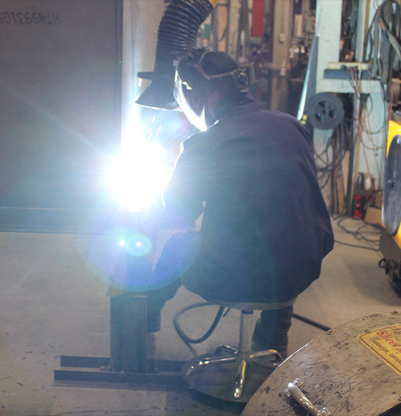 Worker wearing a welding helmet